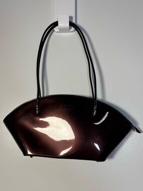 Y2K Beijo patent crescent shoulder bag in deep burgundy